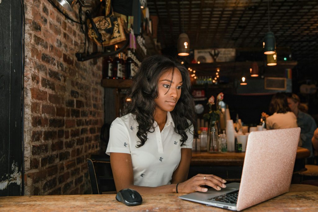 Digital nomad working on a laptop in a café in Ho Chi Minh City or Da Nang.